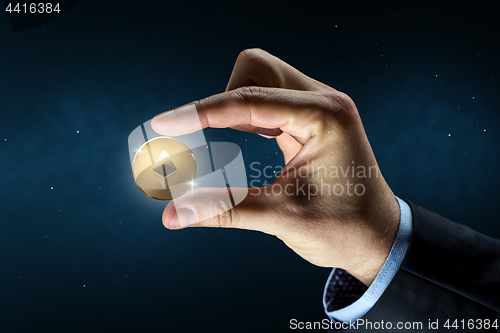 Image of businessman hand with ethereum over binary code