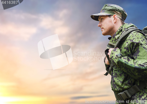 Image of soldier in military uniform with backpack hiking