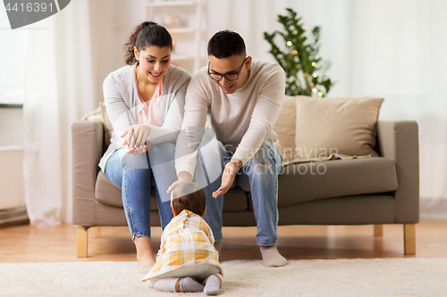 Image of happy family with baby daughter at home