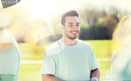 Image of happy volunteer man in park