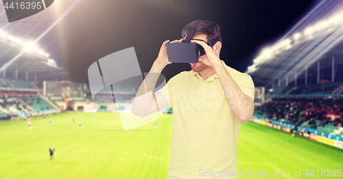 Image of man in virtual reality headset over football field