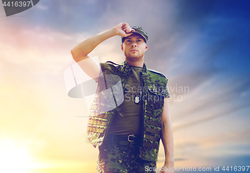 Image of soldier in military uniform over sky background