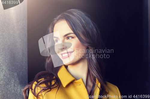 Image of smiling young woman in city