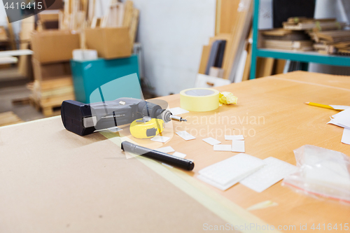 Image of screwdriver and ruler on table at workshop