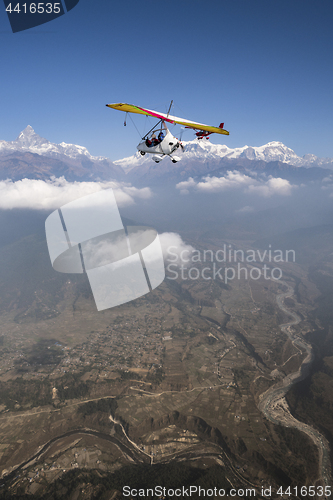 Image of Ultralight plane and trike fly and Machapuchare summit