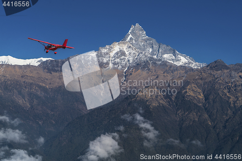 Image of Ultralight plane flies over Pokhara and Machapuchare