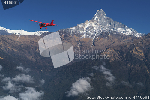 Image of Ultralight plane flies over Pokhara and Machapuchare