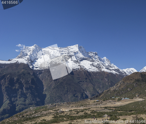 Image of Group of trekkers on a hill and Himalaya summits near Namche Baz