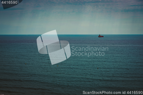 Image of Container ship at anchor on the horizon