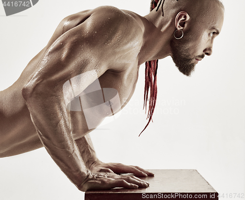 Image of the handsome guy is wrung out on a table in the gym