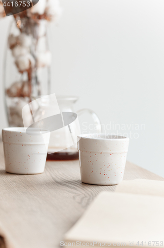 Image of Cup of coffee, branch of tree, wooden windowsill