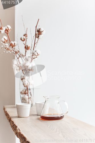 Image of Cup of coffee, branch of tree, wooden windowsill