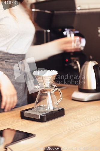 Image of Hand drip coffee, Barista pouring water on coffee ground with filter