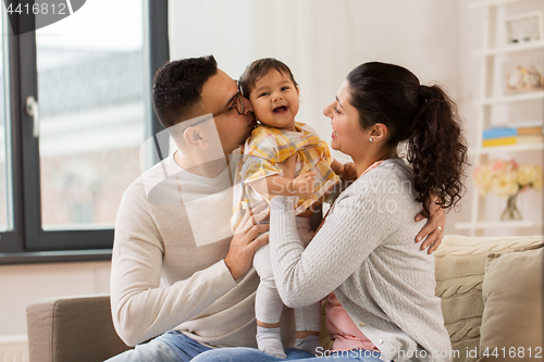 Image of happy family with baby daughter at home