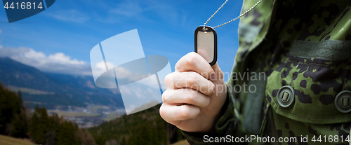 Image of close up of young soldier with military badge