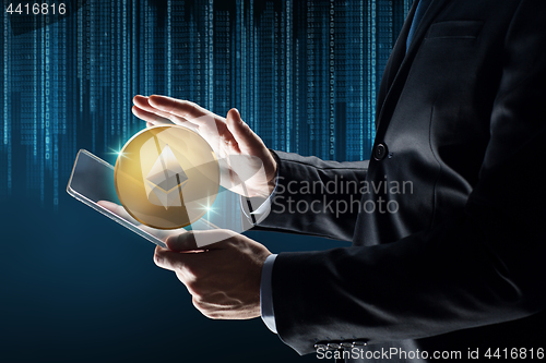 Image of businessman with tablet pc and ethereum hologram