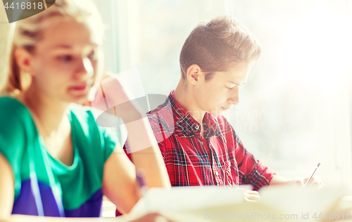 Image of group of students with books writing school test