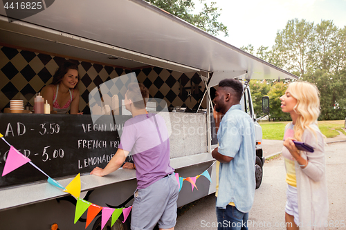 Image of happy customers queue at food truck