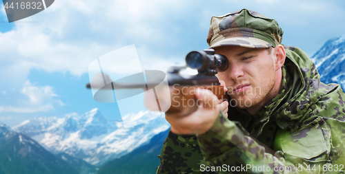 Image of soldier or hunter with gun aiming or shooting