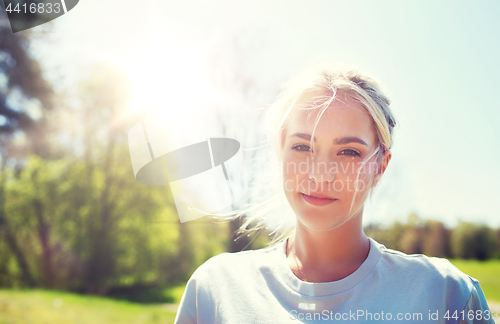 Image of happy young volunteer woman outdoors