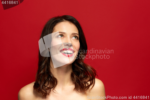 Image of beautiful smiling young woman with red lipstick