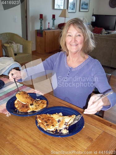 Image of Female eating pancakes.