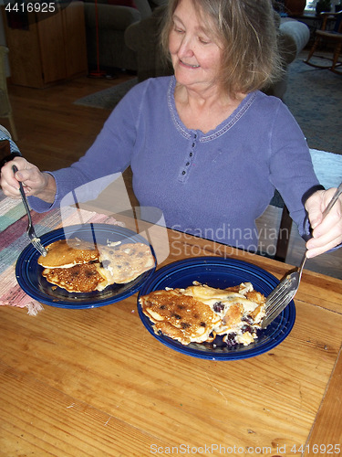 Image of Female eating pancakes.