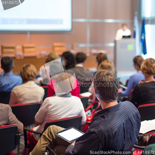 Image of Speaker giving presentation on business conference.