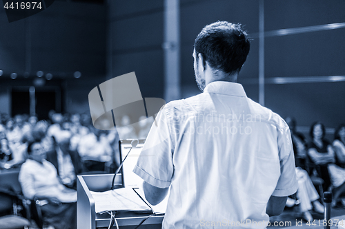 Image of Public speaker giving talk at Business Event.