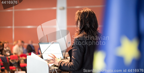 Image of Public speaker giving talk at Business Event.