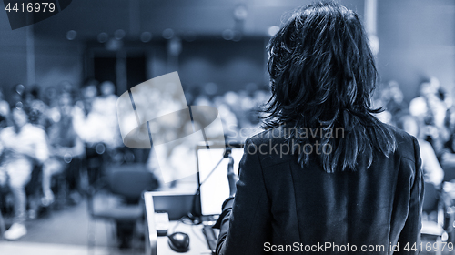 Image of Public speaker giving talk at Business Event.