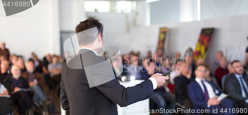 Image of Public speaker giving talk at Business Event.