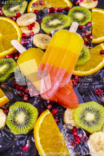 Image of Fruit ice cream on stick with slices fruits  