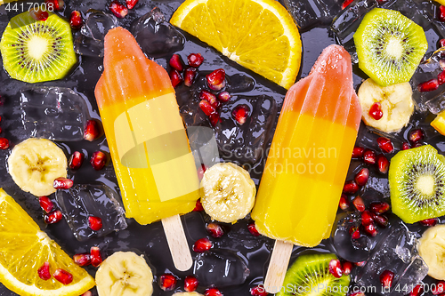 Image of Fruit ice cream on stick with slices fruits 