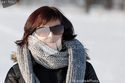 Image of woman with sunglasses without makeup in winter time