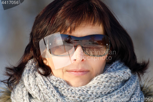 Image of woman with sunglasses without makeup in winter time