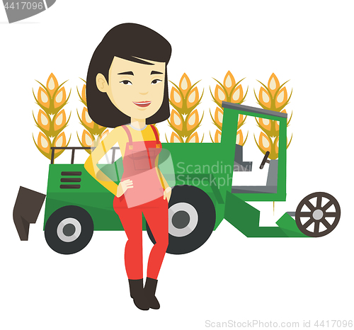 Image of Farmer standing with combine on background.