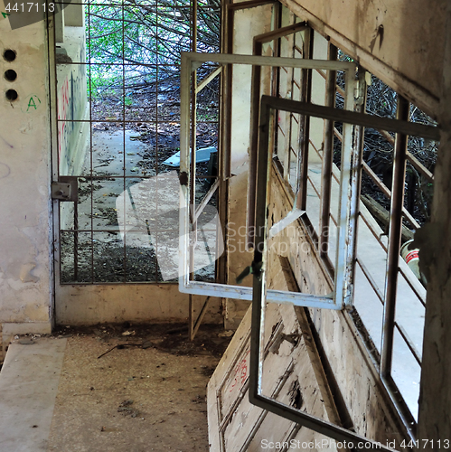 Image of rusty windows in abandoned house