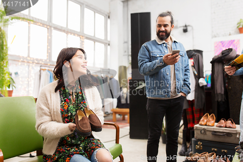 Image of couple choosing footwear at vintage clothing store