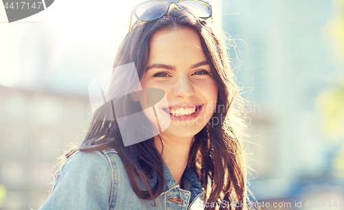Image of happy smiling young woman on summer city street