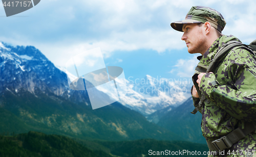 Image of soldier in military uniform with backpack hiking