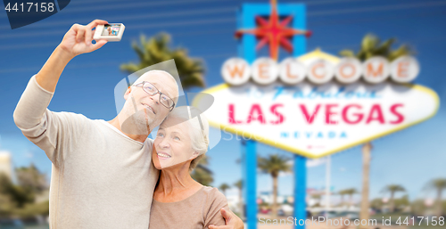 Image of senior couple taking selfie by camera at las vegas