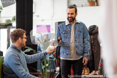 Image of friends choosing shoes at vintage clothing store