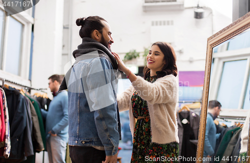 Image of couple choosing clothes at vintage clothing store