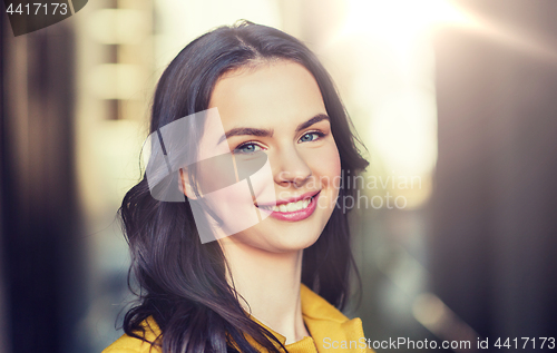 Image of smiling young woman in city
