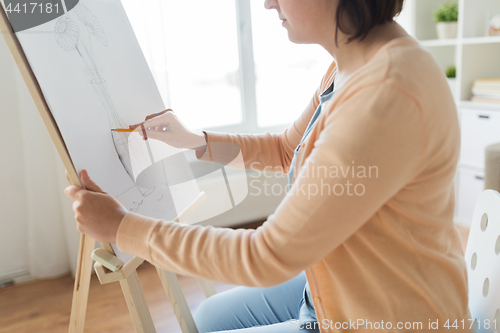 Image of artist with pencil drawing picture at art studio