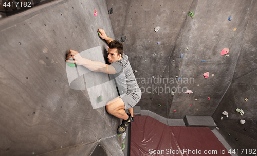 Image of young man exercising at indoor climbing gym