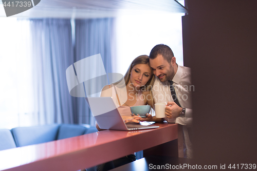 Image of A young couple is preparing for a job and using a laptop