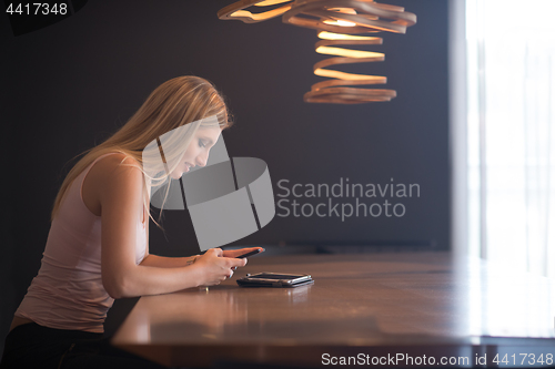 Image of young woman using mobile phone