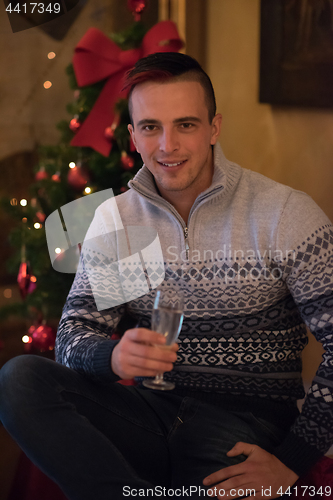 Image of Happy young man with a glass of champagne